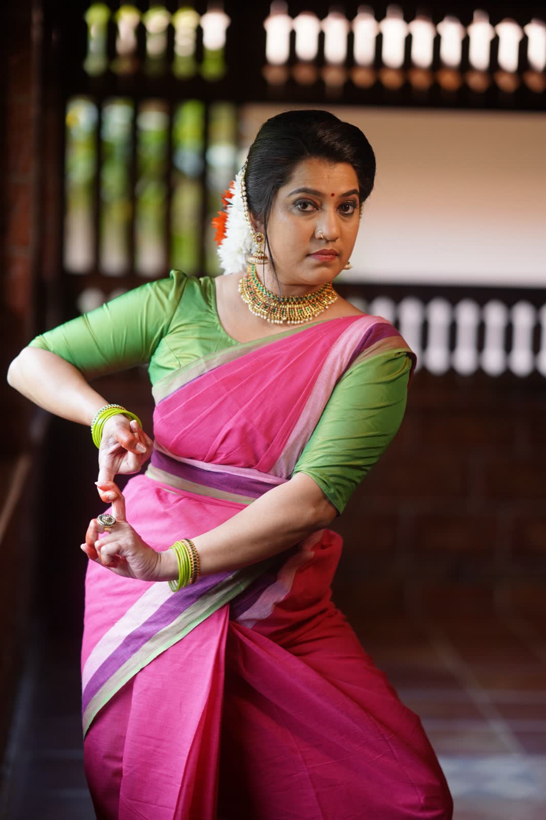 Sumi Ranjith in a pink and green saree