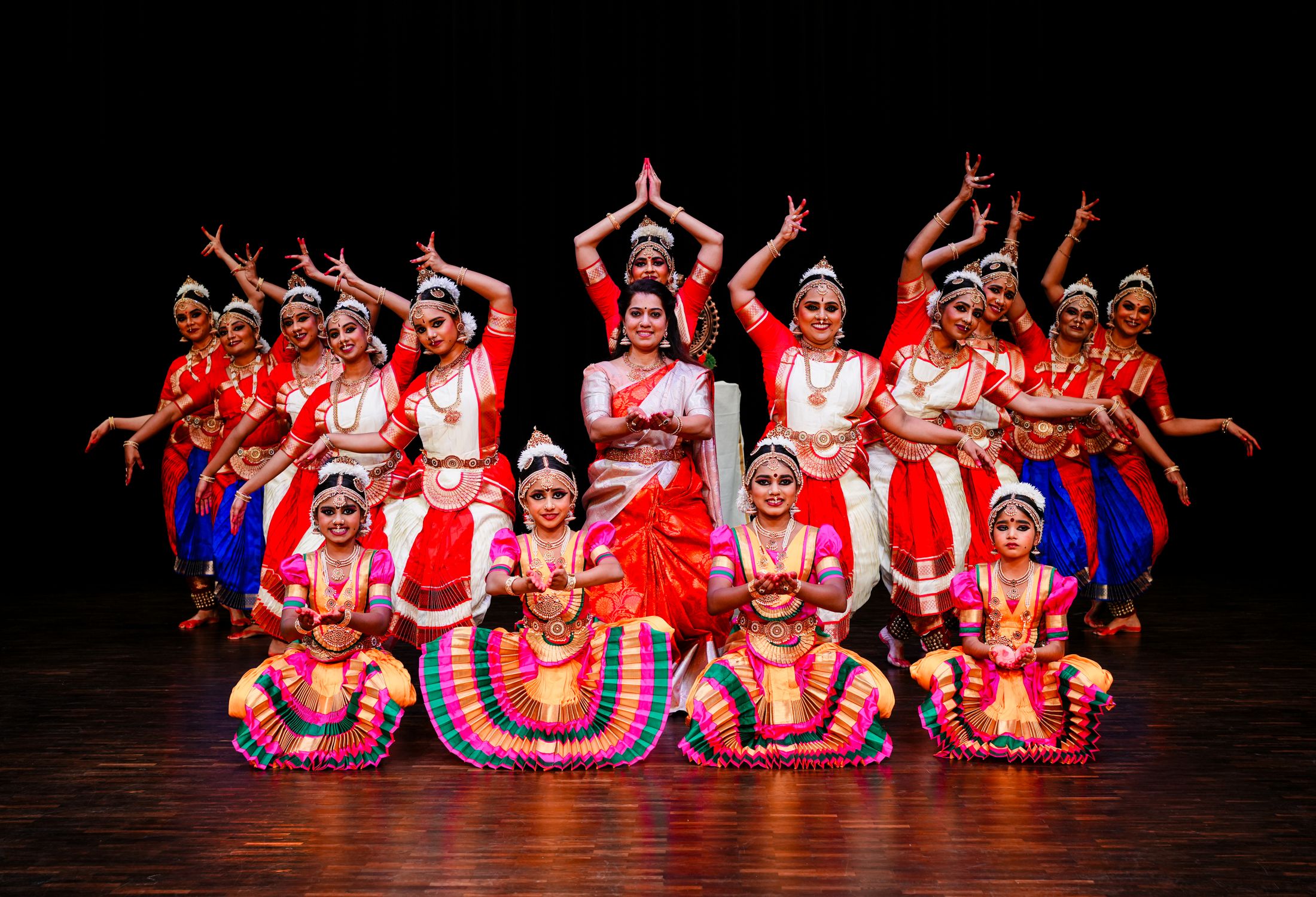 The Navarasa dancers with Sumi Ranjith in the centre, posing together on a dark stage