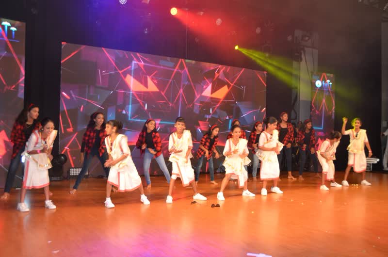 Young dancers performing under stage lights