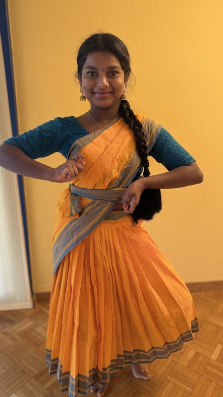 Detail of a student's orange and blue practice saree