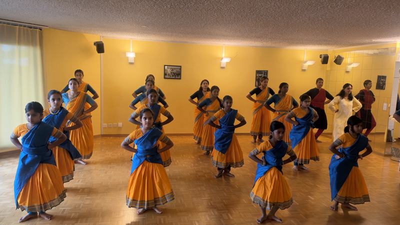 Students dancing in formation at the Pooja